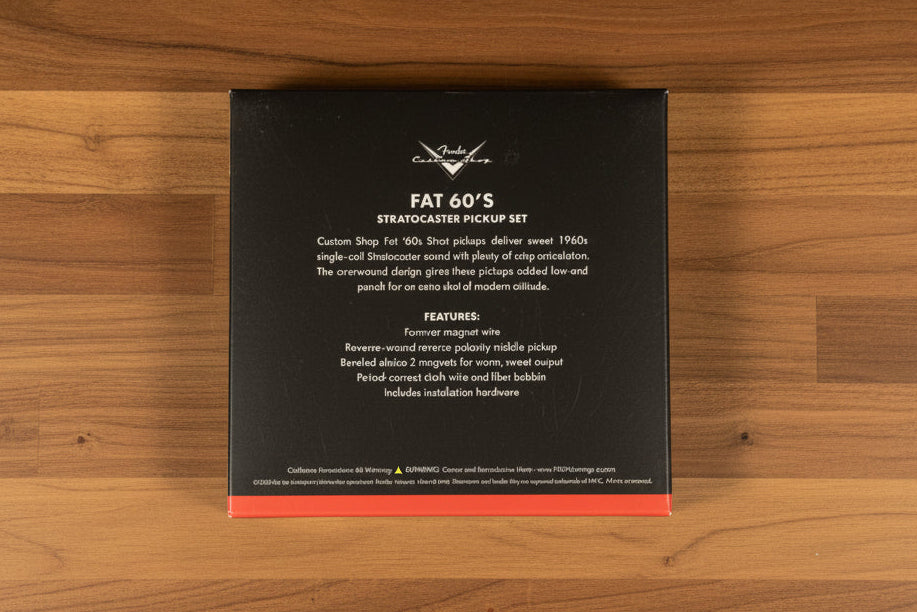 A black metal package for a Stratocaster pickup set, featuring white text and a red bottom stripe, photographed on a dark textured surface.