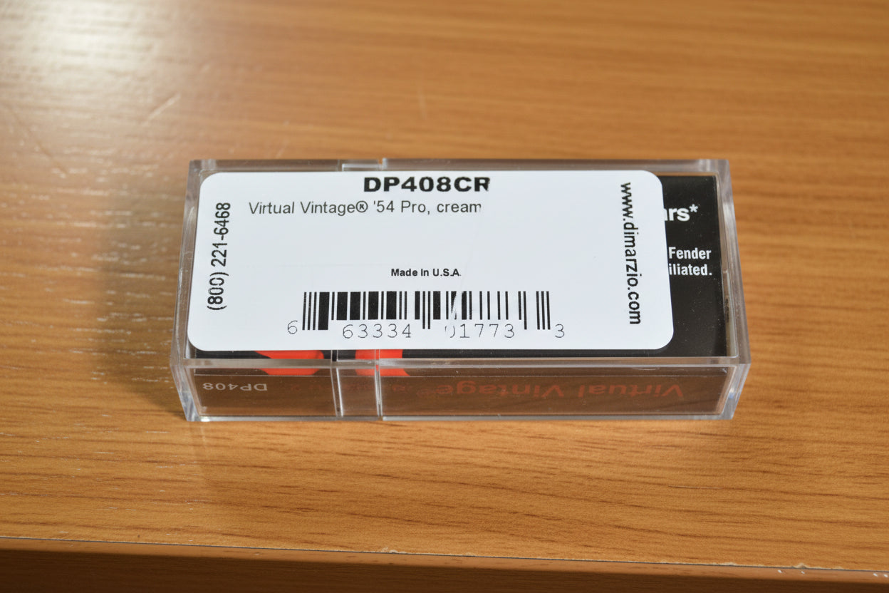A close-up of a clear plastic case containing Virtual Vintage '54 Pro cream-colored guitar strings, with a white label showing the model number DP408CR and website dimarzio.com.